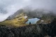 View from Vanatarea lui Buteanu peak of Capra Lake in autumn clouds