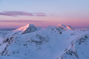 Winter sunrise from Iezerul Caprei peak with snowy landscape