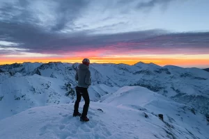 Winter sunrise from Iezerul Caprei peak with snowy landscape