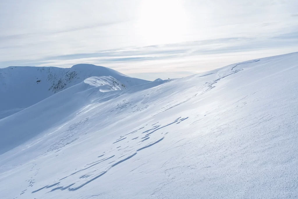 Frozen pond in snowy hills