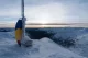 Frozen Romanian flag at Moldoveanu Peak during sunset