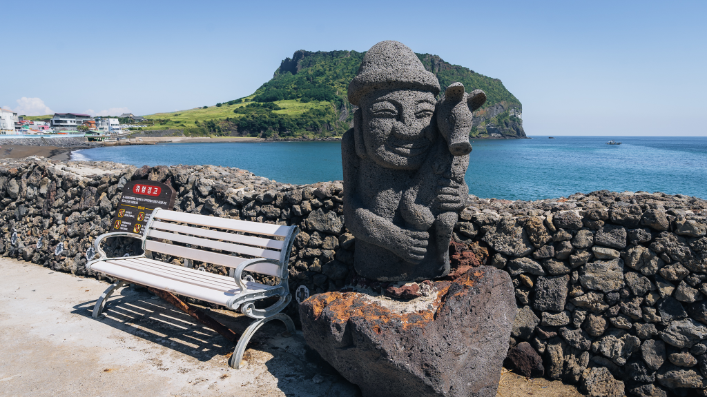 Dol Hareubang statue with Seongsan Ilchulbong in the background
