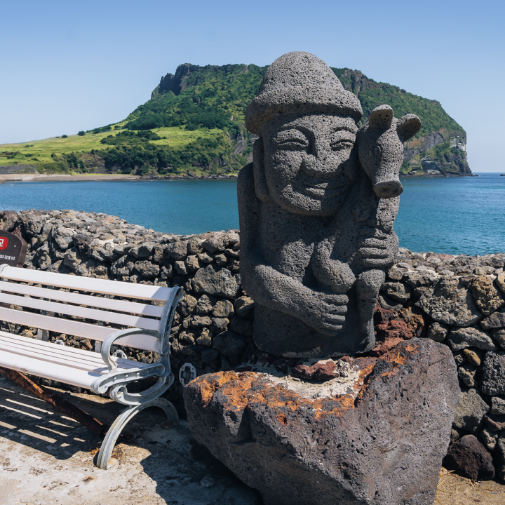 Dol Hareubang statue with Seongsan Ilchulbong in the background